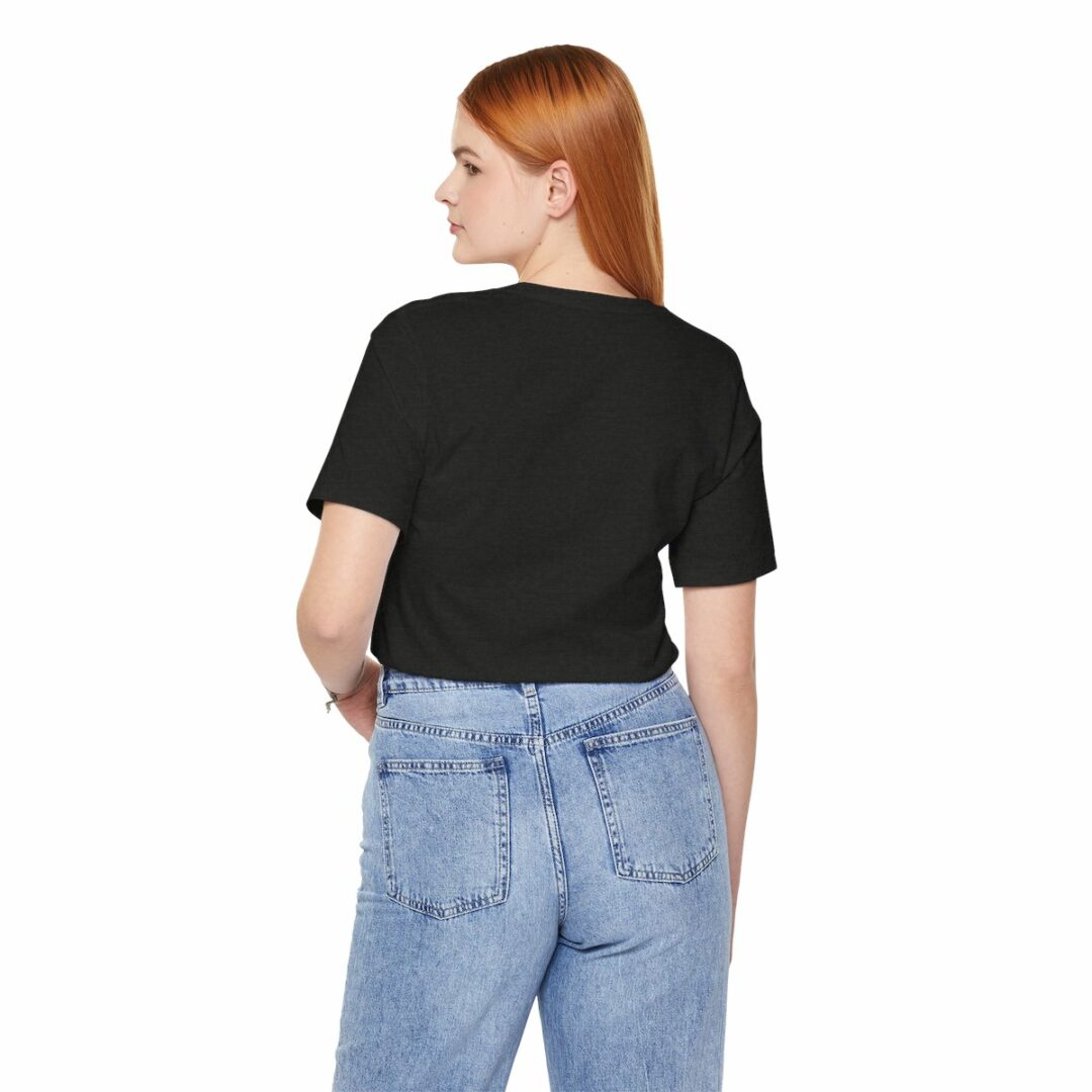 Woman in black t-shirt and blue jeans rear view.